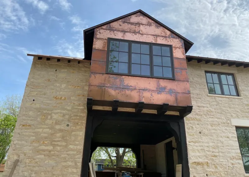 Copper metal panel facade on a stone building for Skylight Installation in Juneau