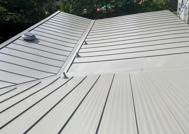 Solar attic fan installed on a metal roof for Roof Ventilation in Juneau